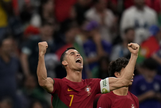 Portugal's Cristiano Ronaldo celebrates after teammate Bruno Fernandes scored Portugal's s opening goal during the World Cup group H football match between Portugal and Uruguay, at the Lusail Stadium in Lusail, Qatar on Monday. [AP/YONHAP]