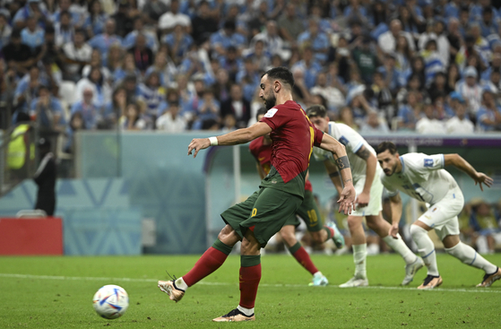 Bruno Fernandes of Portugal scores a penalty goal during the Group H match between Portugal and Uruguay at the 2022 FIFA World Cup at Lusail Stadium in Lusail, Qatar on Monday. [XINHUA/YONHAP]