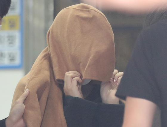 A Korean woman in her 40s, who is a suspect in the case of two children's bodies found inside suitcases in New Zealand in August, walks out of Ulsan Metropolitan Police Agency on Sept. 15, 2022.[YONHAP]