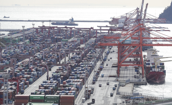 Containers are piled up at a port in Busan on Wednesday. [YONHAP]
