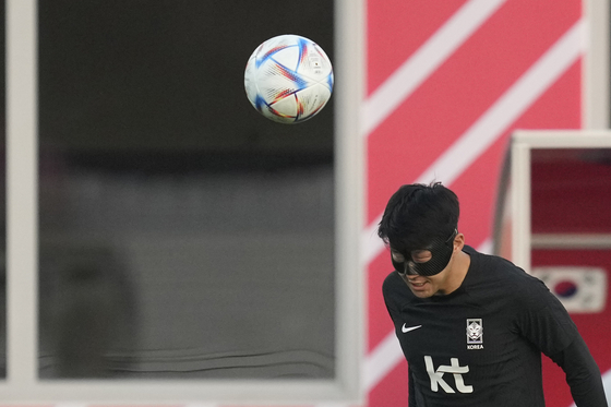 Son Heung-min heads a ball during a training session at Al Egla Training Site in Doha, Qatar, on Wednesday ahead of Korea's final group stage match aginst Portugal scheduled on Friday. [YONHAP]
