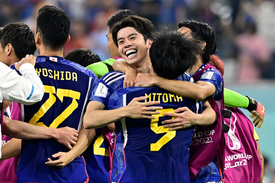 The Japanese national team celebrate after winning the Qatar 2022 World Cup Group E football match between Japan and Spain at the Khalifa International Stadium in Doha on Thursday. [AFP/YONHAP]