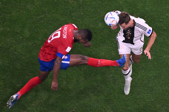 Costa Rica's defender Kendall Waston, left, and Germany's forward Niclas Fuellkrug fight for the ball during the Qatar 2022 World Cup Group E football match between Costa Rica and Germany at the Al-Bayt Stadium in Al Khor, north of Doha on Thursday. [AFP/YONHAP]