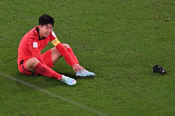 Son Heung-min reacts at the end of the match after beating Portugal 2-1 and qualifying for the knockout stages on Friday evening at the Education City Stadium in Al-Rayyan, west of Doha. [AFP/YONHAP]
