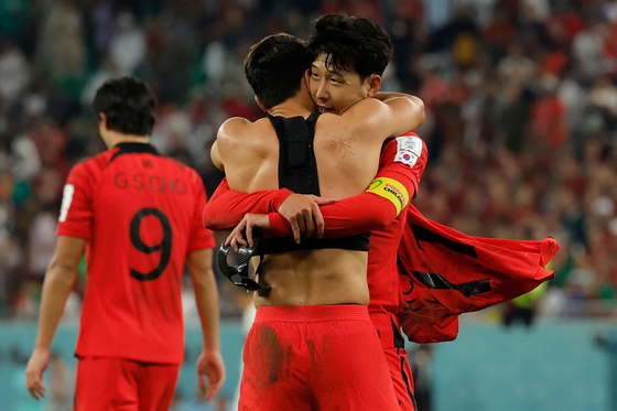Hwang Hee-chan celebrates with Son Heung-min after scoring his team's second goal during the Qatar 2022 World Cup Group H football match between Korea and Portugal at the Education City Stadium in Al-Rayyan, west of Doha on Friday. [AFP/YONHAP]