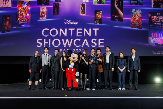 The cast and directors of upcoming Korean Disney+ originals "Connect," "Big Bet" and "Call It Love" pose with Mickey Mouse at the Asia Pacific (APAC) Disney Content Showcase held at Marina Bay Sands Singapore on Thursday. [THE WALT DISNEY COMPANY]