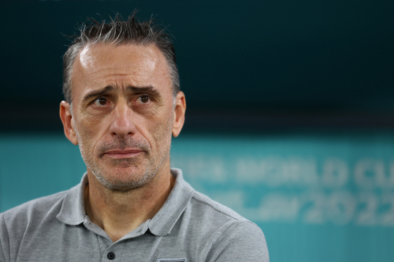 Korean national team head coach Paulo Bento watches the pitch before the round of 16 match between Brazil and Korea at Stadium 974, Doha, Qatar on Monday. [REUTERS/YONHAP]