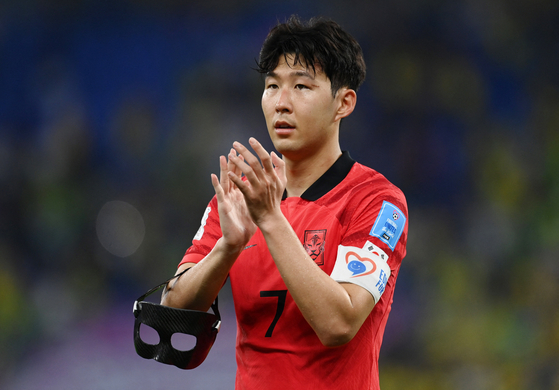 Son Heung-min applauds fans after Brazil beat Korea 4-1 in a round of 16 match at the 2022 Qatar World Cup at Stadium 974 in Doha, Qatar on Monday. [REUTERS/YONHAP]