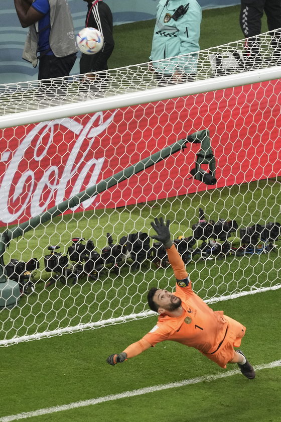 France's goalkeeper Hugo Lloris watches the ball go over the bar after England's Harry Kane took a penalty shot during the quarterfinal match between England and France on Saturday. [XINHUA/YONHAP]