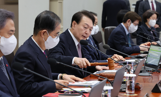 President Yoon Suk-yeol starts a cabinet meeting at the Yongsan office on Tuesday where issues on national health insurance were raised. [YONHAP] 
