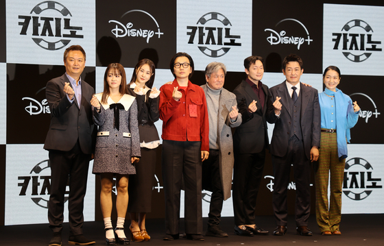 From left, director Kang Yun-sung, actors Ryu Hyun-kyung, Son Eun-seo, Lee Dong-hwi, Choi Min-sik, Son Suk-ku, Heo Sung-tae and Kim Joo-ryoung pose for a photo at a local press event to promote Disney+'s original drama series "Big Bet" at JW Marriott Dongdaemun Square Seoul in eastern Seoul on Wednesday. [YONHAP]