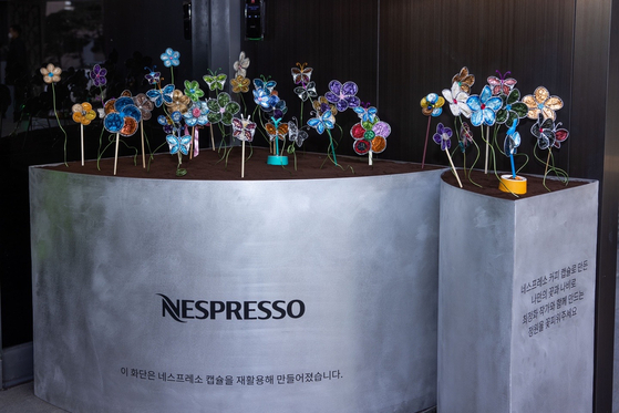 A bed of flowers and butterflies made of aluminum Nespresso coffee capsules [NESPRESSO]