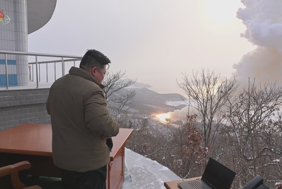 North Korean leader Kim Jong-un watches a test of a solid-fuel engine at the Sohae Satellite Testing Ground in Tongchang-ri, North Pyongan Province on Thursday in this footage released by Pyongyang's state-controlled Korean Central Television. [YONHAP]