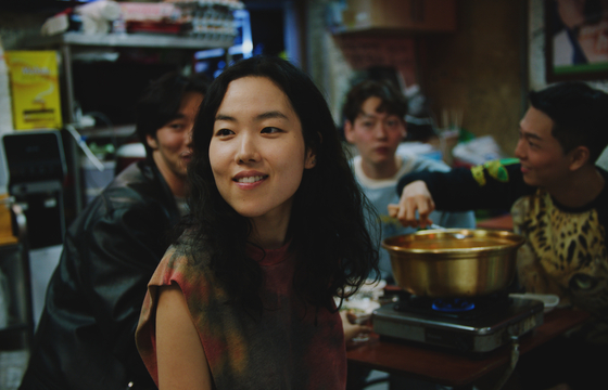 Park Ji-min as Freddie at a bar with Korean friends and acquaintances. [AT9FILM]