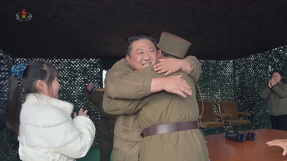North Korean leader Kim Jong-un, center, rejoices after the regime successfully tested its Hwasong-17 intercontinental ballistic missile (ICBM) on Nov. 18 in footage recorded by the state-controlled Korean Central Television. [YONHAP] 