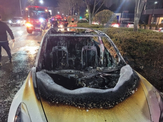 A Tesla went up in flames on Monday morning on a road in Busan. [BUSAN METROPOLITAN POLICE AGENCY]