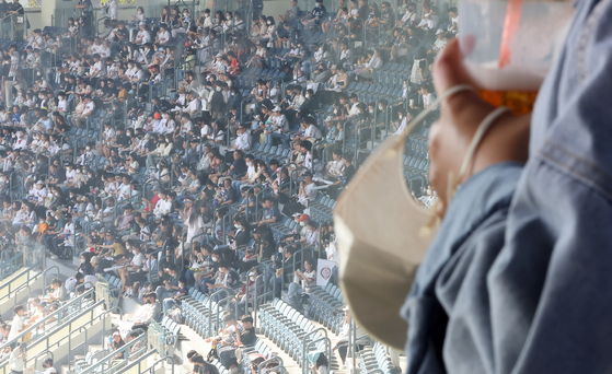 A spectator cheers during a baseball game in Seoul on Sept. 25 without wearing a mask after the government lifted the outdoor mask mandate. [YONHAP]