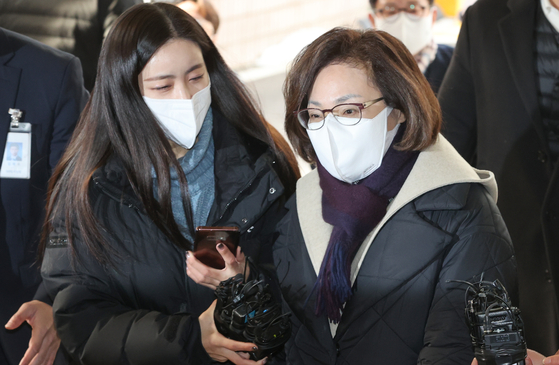 Park Hee-young, right, head of the Yongsan District Office, arrives at the Seoul Western District Court on Monday to attend a hearing for her pre-trial detention warrant. [YONHAP]