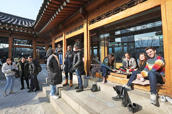 Foreigners from different countries swarm to Onion Aguk on Dec. 27, to experience Korea's cafe culture and its hanok (Korean traditional house). [PARK SANG-MOON]