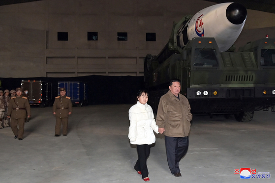 North Korean leader Kim Jong-un holds hands with his daughter Ju-ae as they prepare to watch the launch of a new Hwasong-17 intercontinental ballistic missile (ICBM) at Pyongyang International Airport on Nov. 18 in a photo released by the North's official Korean Central News Agency (KCNA) on Nov. 19, 2022. [YONHAP]