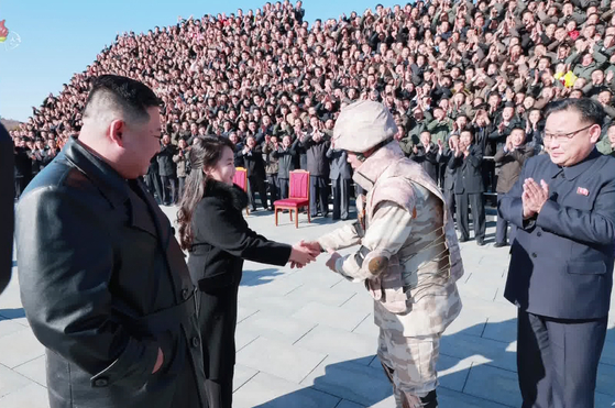 A senior North Korean military official is seen bowing to Kim Ju-ae at the commemorative photo shoot in a screen capture from the North’s Korean Central Television on Nov. 27. [YONHAP]