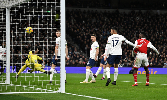 Tottenham Hotspur's Hugo Lloris scores an own goal in a match against Arsenal at Tottenham Hotspur Stadium in London on Sunday.  [REUTERS/YONHAP]