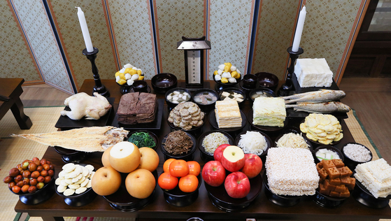Charye, the rite of putting out food for ancestors, involves a table full of various traditional food. [YONHAP]