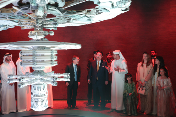 President Yoon Suk Yeol, center, views an exhibition ahead of the Future Vision Forum in Dubai on Tuesday, the last day of his state visit to the United Arab Emirates. [JOINT PRESS CORPS]