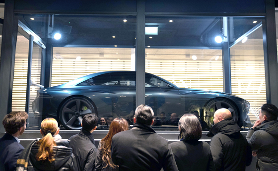 Hyundai Motor's Genesis X, a high-performance electric vehicle concept car, is displayed in a glass Busan Expo 2030 display case at the Ameron Hotel in Davos, Switzerland, where Korea Night 2023 took place during the World Economic Forum. Korea Night 2023 was hosted by the Korea Chamber of Commerce and Industry and the Busan Expo bidding committee member companies to promote the city's bid to host the 2030 World Expo. [HYUNDAI MOTOR]