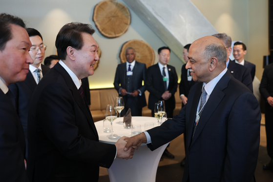 President Yoon Suk Yeol, left, shakes hands with IBM CEO Arvind Krishna at the Global Business Leadership Luncheon at a hotel in Davos, Switzerland Wednesday. [JOINT PRESS CORPS]