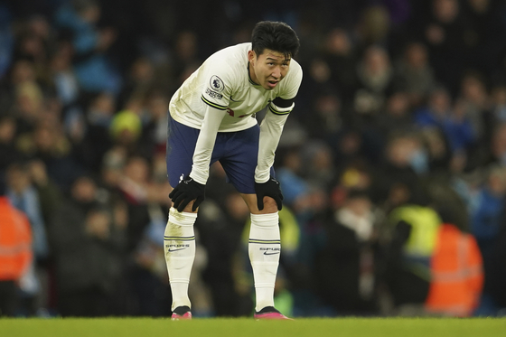 Tottenham's Son Heung-min stands in dejection after Manchester City's Riyad Mahrez scores his side's fourth goal during a Premier League match at the Etihad Stadium in Manchester on Thursday.  [AP/YONHAP]