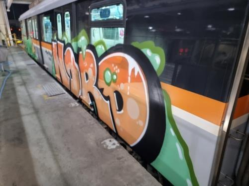 A suibway car with graffiti. A 27 year-old American and a 28 year-old Italian is suspected of painting the cars last year. [iNCHEON TRANSIT CORPORATION]