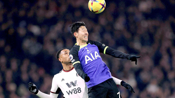 Tottenham's Son Heung-min wins a header under pressure from Fulham's Dutch defender Kenny Tete during a Premier League match between Fulham and Tottenham Hotspur at Craven Cottage in London on Monday.  [AFP/YONHAP]