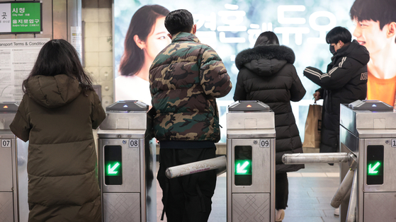 Passengers pass gates to board the subway at Sinchon Station in western Seoul on Tuesday afternoon. The Seoul city government is considering either a 300-won or 400-won ($0.32) hike for subway fares. [YONHAP]