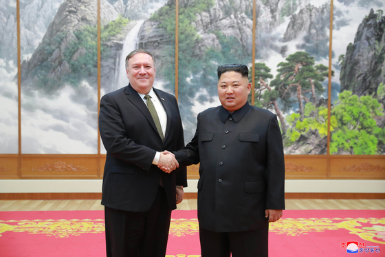 Then U.S. Secretary of State Mike Pompeo, left, shaking hands with North Korean leader Kim Jong-un during their meeting in Pyongyang on Oct. 7, 2018. [KOREAN CENTRAL NEWS AGENCY]