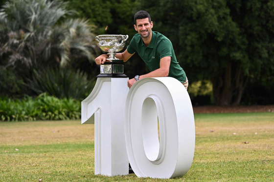Novak Djokovic celebrates with the Norman Brookes Challenge Cup trophy a day after his victory against Greece's Stefanos Tsitsipas in the men's singles final match of the Australian Open tennis tournament in Melbourne on Sunday. [YONHAP]
