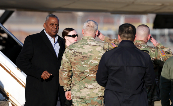 U.S. Defense Secretary Lloyd Austin, left, arrives in Korea at Osan Air Base on Monday. [JOINT PRESS CORPS]