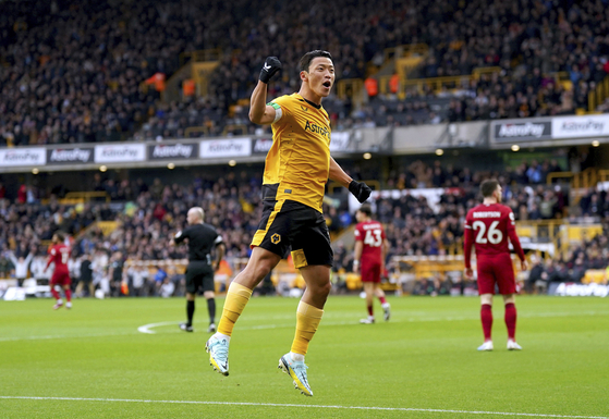 Wolverhampton Wanderers' Hwang Hee-chan celebrates after forcing an own goal off Liverpool's Joel Matip during a Premier League match at Molineux Stadium in Wolverhampton, England on Saturday. [AP/YONHAP]