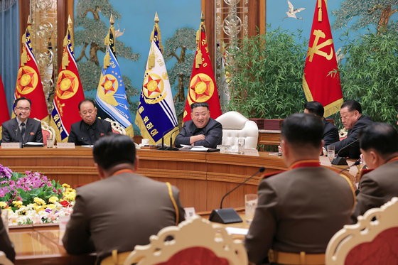 North Korean leader Kim Jong-un, center, presides over an enlarged meeting of the Central Military Commission of the ruling Workers' Party of Korea on Monday. [KOREAN CENTRAL NEWS AGENCY]