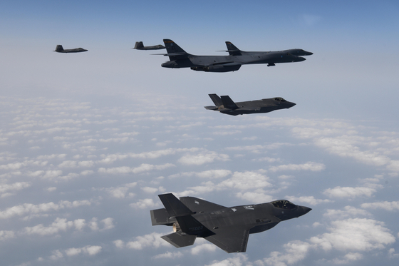 F-35A fighters from the South Korean Air Force fly alongside F-22 and F-35B fighters from the U.S. Air Force in the skies above the Yellow Sea on Wednesday. [DEFENSE MINISTRY]