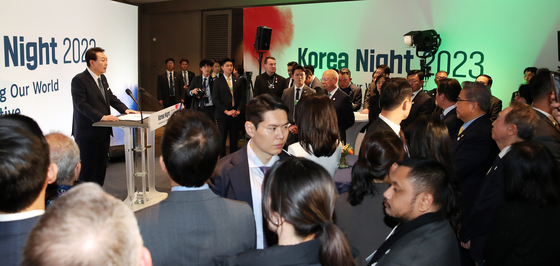 President Yoon Suk Yeol, left, speaks at the Korea Night 2023 on the sidelines of the World Economic Forum in Davos, Switzerland, Wednesday. [JOINT PRESS CORPS] 