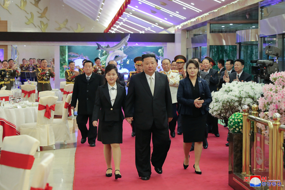 North Korean leader Kim Jong-un, center, attends a banquet celebrating the 75th anniversary of the founding of the Korean People's Army's with his daughter and wife on Tuesday. [KOREAN CENTRAL NEWS AGENCY]