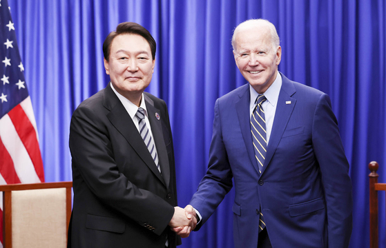 President Yoon Suk Yeol, left, and U.S. President Joe Biden shake hands after bilateral talks in Phnom Penh, Cambodia on Nov. 13, 2022, on the sidelines of Asean meetings. [PRESIDENTIAL OFFICE]