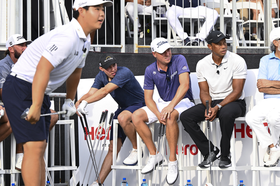 Matt Fitzpatrick, Justin Thomas, Tiger Woods and Dr. Pawan Munjal, chairman & CEO of Hero MotoCorp, watch as Kim Joo-hyung hits shots at the Hero Shot event prior to the Hero World Challenge at Albany on Nov. 29, 2022 in Nassau, Bahamas.  [GETTY IMAGES]