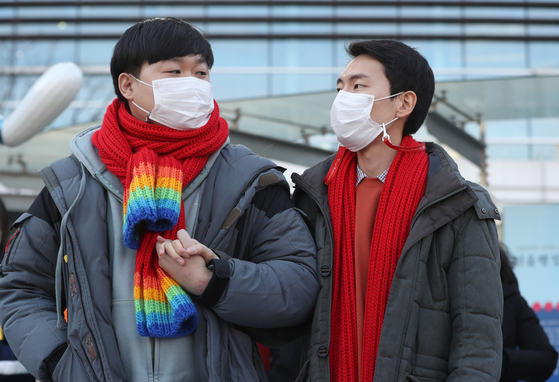 So Seong-wook, left, and Kim Yong-min, a gay couple, stand in front of the Seoul Administrative Court in southern Seoul on Jan. 7, 2022, after the court ruled against them. [NEWS1]
