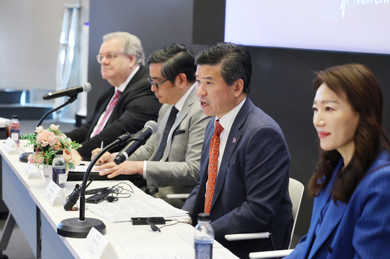 James Kim, second from right, CEO and chairman of Amcham, speaks during a press conference held in western Seoul on Thursday. [AMCHAM]