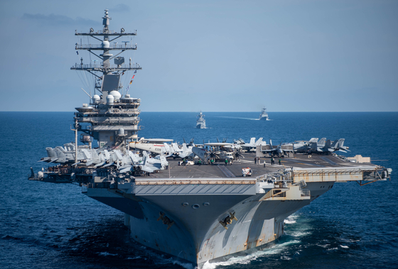 The U.S. Navy’s aircraft carrier USS Ronald Reagan, front, and South Korean Navy ships Munmu the Great and Gangwon steam in formation in waters east of the Korean Peninsula in a photograph released by the U.S. Navy on Sept. 29. [U.S. NAVY]