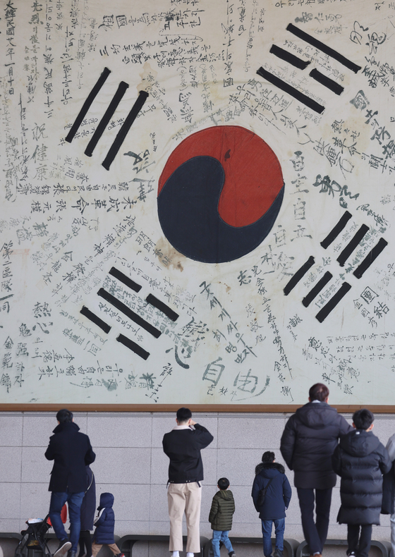 A massive Korean national flag signed by independence fighters during the Japanese colonial era hangs at the Independence Hall of Korea in Cheonan, South Chungcheong, on Sunday ahead of the 104th anniversary of the March 1 Movement. The independence movement that started on the nation’s capital on March 1, 1919, with 33 Korean leaders’ Proclamation of Independence spread to other regions of the country as a demonstration against the Japanese occupation. [YONHAP] 