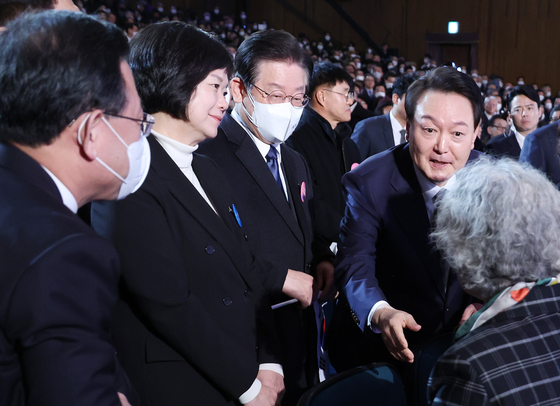 President Yoon Suk Yeol, right, and Democratic Party Chairman Lee Jae-myung, second from right, have a brief encounter at a ceremony marking the 104th anniversary of the March 1 Independence Movement at the Memorial Hall of Yu Gwan-sun in central Seoul Wednesday. [JOINT PRESS CORPS]
