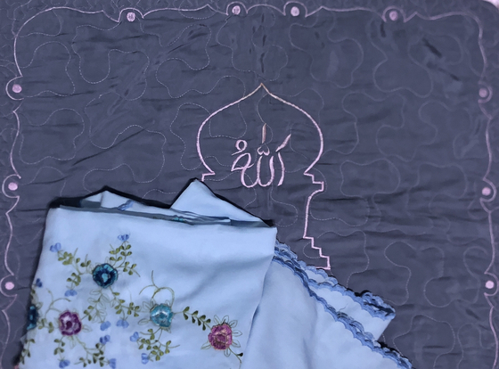 Islam mat and dress used for praying [LATIFA SEKARINI]
